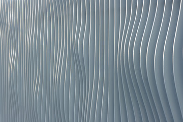 Metallic construction of the urban fence as background. Corrugated abstract stripes of metallic fence.