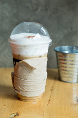 Iced latte with straw in plastic cup