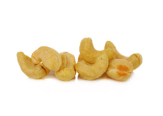 Roasted cashew nuts whith salt on white background
