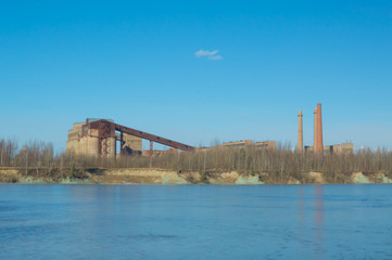 plant with pipes standing on the banks of the river.