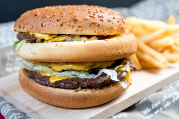 Fototapeta na wymiar Cheese burger - American cheese burger with Golden French fries