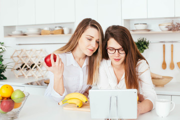 Young caucasian women cooking in the kitchen