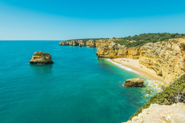 Fototapeta na wymiar Beautiful idyllic sandy beach and turquoise water in Algarve,Portugal