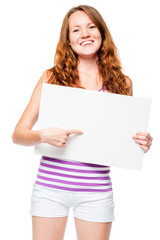 Fototapeta premium Smiling girl with a poster in her hands presents a blank