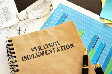 Book with title strategy implementation and financial data.