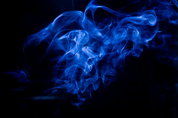 Obraz premium Blue toxic fumes movement on a black background.
