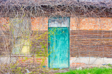 Vintage beautiful old locked wooden door and window with wooden sticks