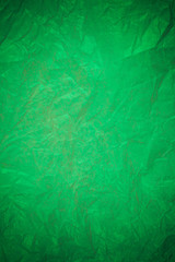 Crumpled green paper recycling background.