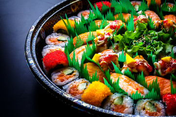 Japanese Sushi contains salmon, shrimp and rice with black background