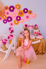 A girl is sitting on a gift box