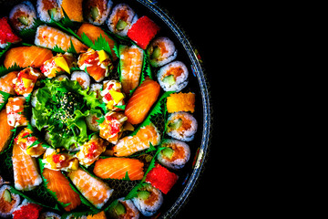 Japanese Sushi contains salmon, shrimp and rice with black background