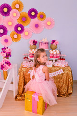 A girl is sitting on a gift box