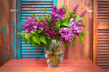 Lilac on colored wooden background