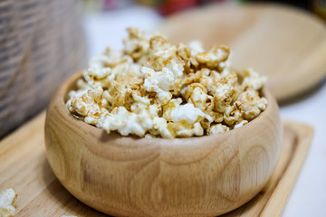 Sweet caramel popcorn in wooden bowl