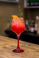 Red cocktail on the wood plate