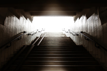 Sepia urban subway stairs with light in the end without people photo