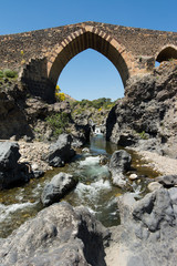 Fototapeta na wymiar Medieval bridge of Adrano, Sicily, of arabic origin and saracen