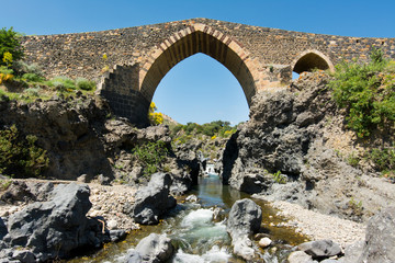 Fototapeta na wymiar Medieval bridge of Adrano, Sicily, of arabic origin and saracen