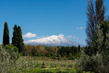 snow on mountain etna, big italian volcano, seen from the plain