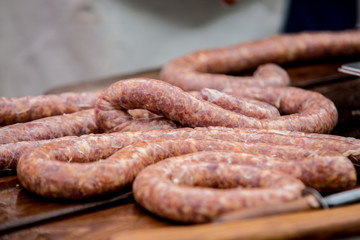 Butcher making sausages in meat factory.
