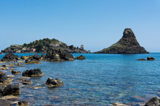 Cyclops islands, Acitrezza, Sicily. Basalt rocks on the sea