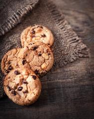 Chocolate chip cookies on dark old wooden table with place for text.,  freshly baked. Selective Focus with Copy space.