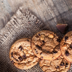 Chocolate cookies on dark  napkin on wooden table. Closeup of a group of assorted cookies..