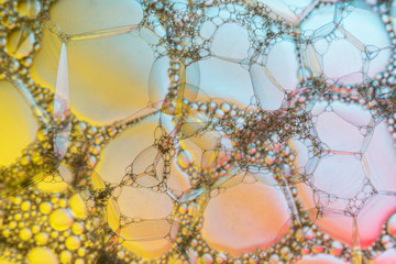 Abstract background of yellow bubbles with backlighting, closeup