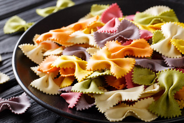Beautiful Italian uncooked colored farfalle pasta close-up. horizontal