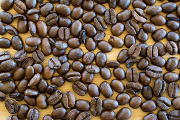 Coffee beans on wooden table.