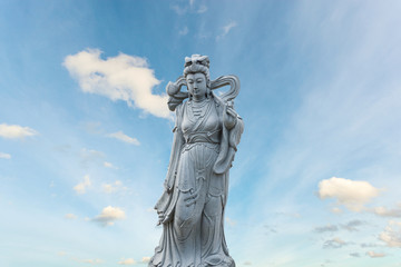 Guan Yin statue stone god of china on sky background.
