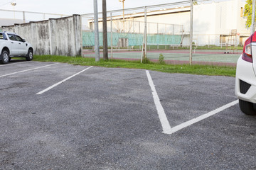 Empty Space in a Parking Lot near tennis court.