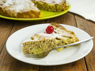 Slice of apple pie on white plate