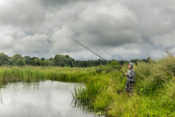 Teenboy fishing on the small river