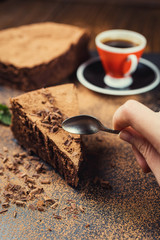 chocolate cake with Candies and cup of coffee,Chocolate cake with a cut piece and blade on gray background,closeup,Dark chocolate cake,vegan chocolate cake,Tasty chocolate cake on wooden background