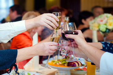 People hold in hands glasses with white champagne. Toasting at the wedding party