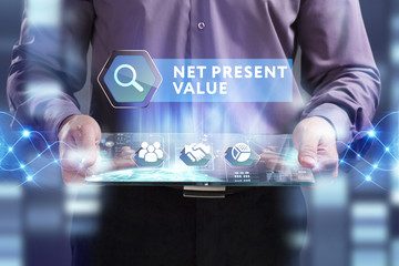 Business, Technology, Internet and network concept. Young businessman working on a virtual screen of the future and sees the inscription: Net present value