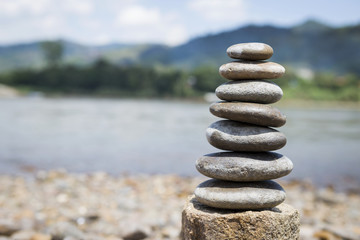 Natural background of stone stack over blurred river background, outdoor day light
