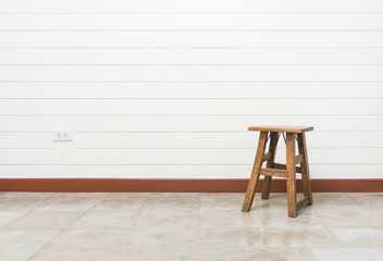 Wood antique brown chair in empty room with white wooden wall background and granite floor for interior design use