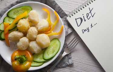boiled potato with fresh vegetables on plate, dietetic food