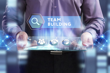 Business, Technology, Internet and network concept. Young businessman working on a virtual screen of the future and sees the inscription: Team building