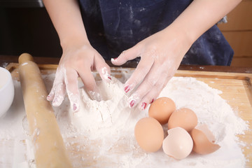 Fototapeta premium Woman hands knead dough.