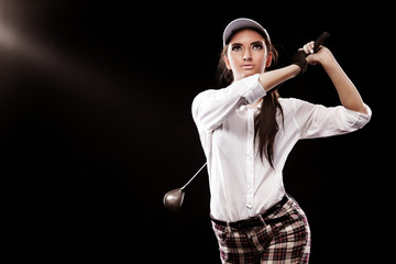 Woman golfer hitting the ball isolated on black background. Copy space. Ad concept.