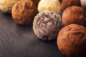 Chocolate truffle,Truffle chocolate candies with cocoa powder.Chocolate candies collection.Assorted chocolate truffles with cocoa powder, coconut and chopped hazelnuts on a dessert plate.