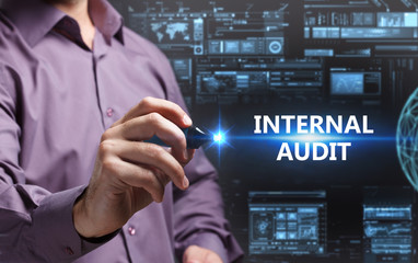 Business, Technology, Internet and network concept. Young businessman working on a virtual screen of the future and sees the inscription: Internal audit