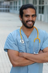 Ethnic doctor man posing happy with arms crossed - Stock image