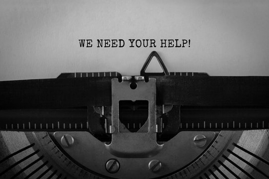 Text We Need Your Help typed on retro typewriter