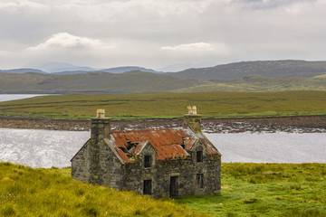 Decayed house in the Scottish Highlands at Callanish stonecircle on Lewis Island, Scotland, Great...