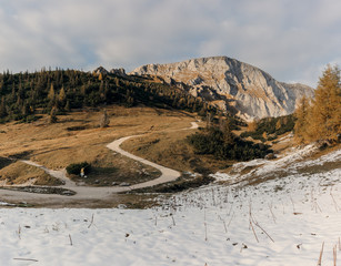 The road from mount Jenner through the autumn forest to the town of Berchtesgaden, Germany