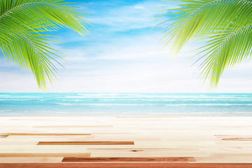 Fototapeta na wymiar Empty wooden table and palm leafs with party on beach background blurred. Concept Summer, Beach, Sea, Relax, Party.